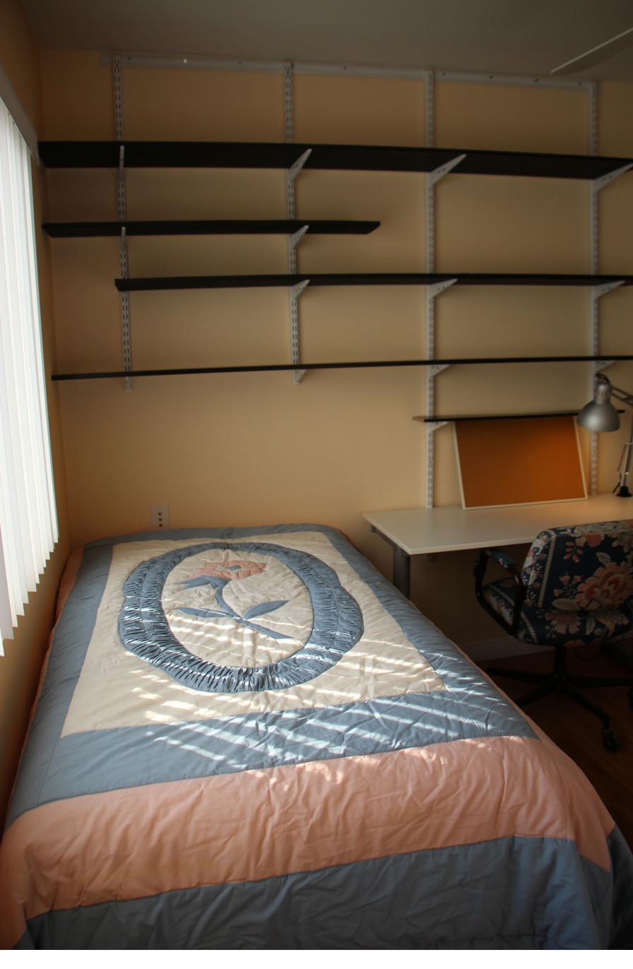 Student bedroom cork board adjustable shelving CSULA off campus housing
