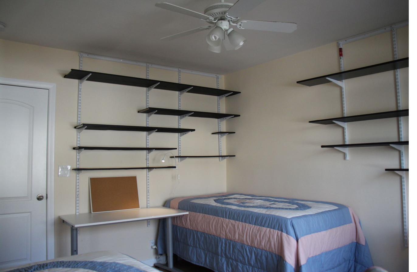 Shared bedroom ceiling fan desk wall shelving student housing near CSULA
