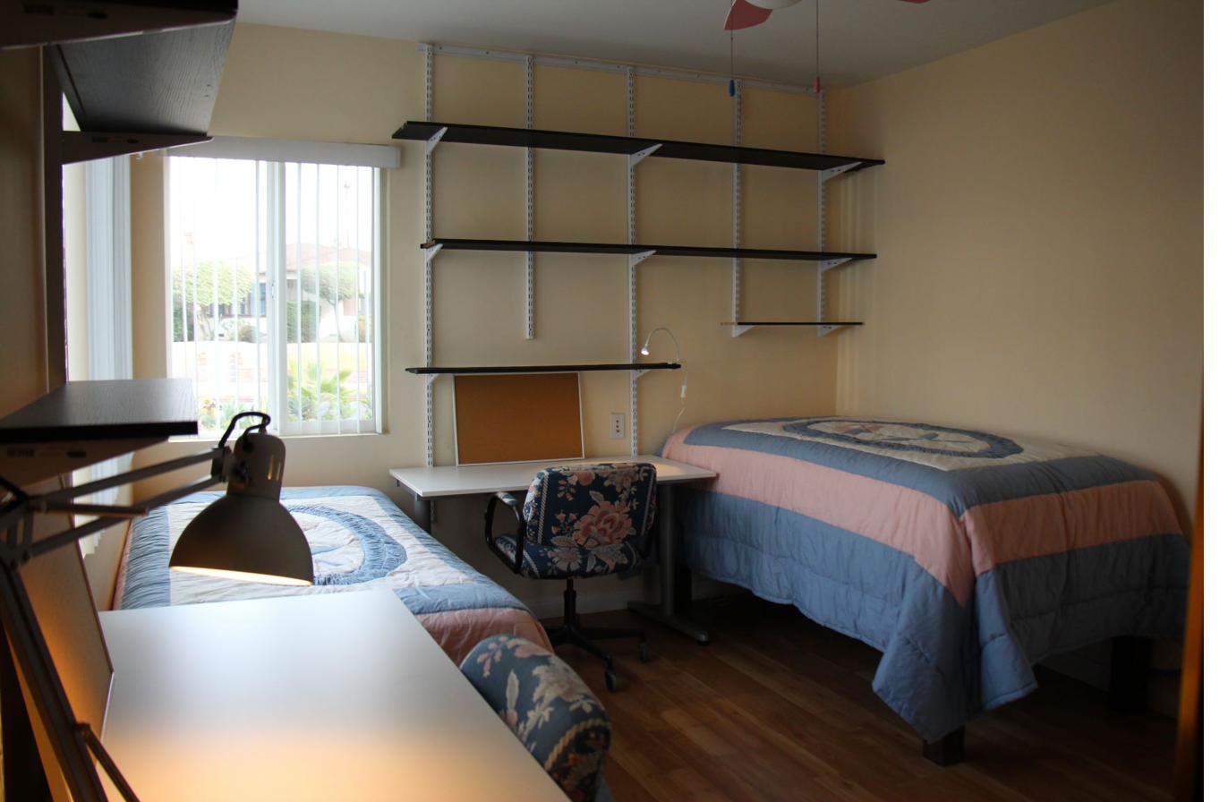 Furnished bedroom natural light wall shelving near CSULA Cal State LA