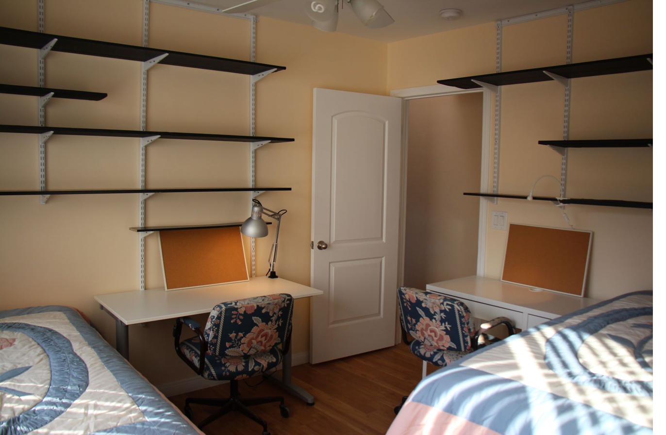 Bedroom extensive wall shelving study desk CSULA student housing Los Angeles